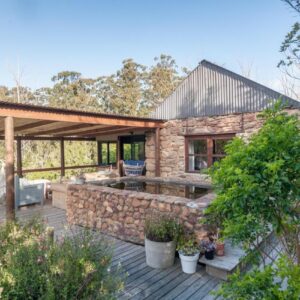 A stone house with a stone wall at Oakhurst Farm Cottages in Wilderness