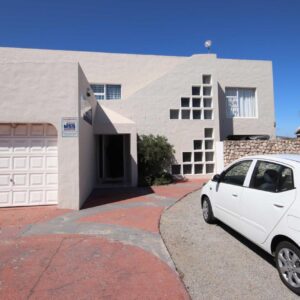 A white car parked in front of a house at Ocean House Holiday Accommodation in Langebaan