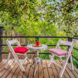 A table and two chairs on a wooden deck at O'Darling On The Hill in Cape Town