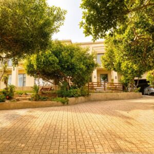 A cobblestone street in front of a building at On Appointment at the Sea in Wilderness