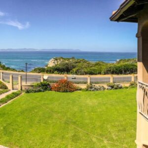 A balcony of a house with a view of the ocean at On The Cliff Guest House in Hermanus