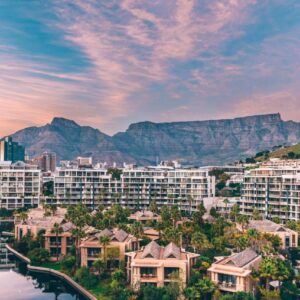 Resort buildings beside a canal with Table Mountain in the background at One&Only Cape Town