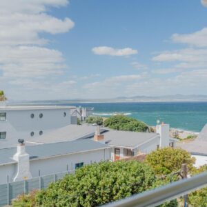 A view of the ocean from the balcony of a house at One Marine Drive Boutique Hotel & Spa by The Living Journey Collection in Hermanus
