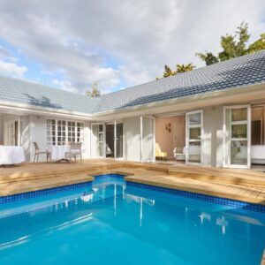 A swimming pool in the backyard of a house at Outeniqua Inn in George