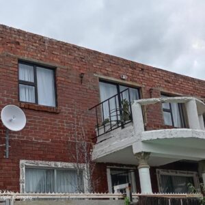 A brick building with a balcony on the side of it at Paradise view in Paarl