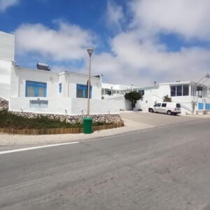 Whitewashed buildings with blue-framed windows beside the street at Paternoster Lodge in Paternoster
