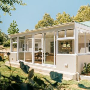 A large white house with large windows at Patryssenvalleij Farm and Cottages in Stellenbosch