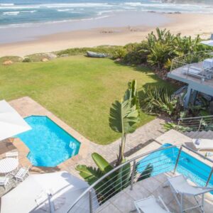 An aerial view of a house with a pool and the beach at Peacehaven on Sea in Wilderness