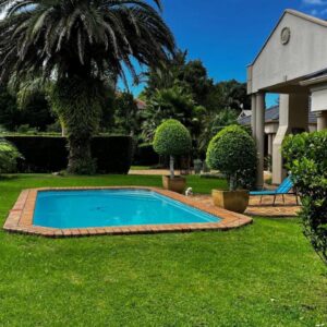 A swimming pool in the yard of a house at Plovers Rest in George