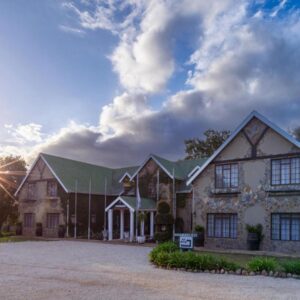 A large house with a driveway in front of it at Portland Manor in Knysna