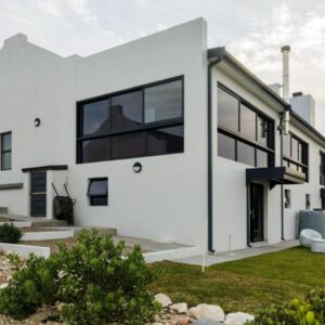 A white house with black windows at Protea32 in Agulhas