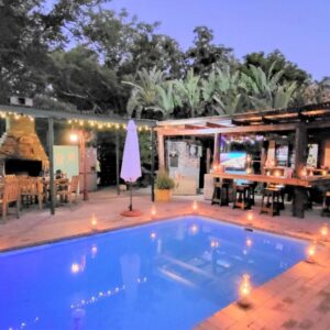 A swimming pool in a patio with a restaurant at Rosenhof Manor House - since 1847 in Clanwilliam