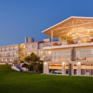 A large building with a lawn in front of it at Saldanha Bay Hotel in Saldanha