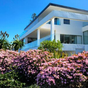 A house with pink flowers in front of it at Salt & Sand in Wilderness