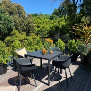 A table and chairs on a wooden deck at SAN Constantia in Cape Town