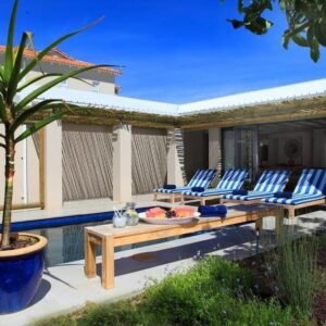 A courtyard swimming pool with loungers at Scallop Lodge in Plettenberg Bay