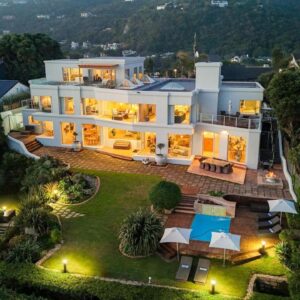 An aerial view of a large house with lights at SEASENSE Boutique Beach Villa in Wilderness