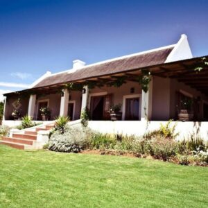 A house with a grass yard in front of it at Secluded Fynbos Retreat in Piketberg