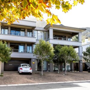 A white car parked in front of a building at Selkirk House in Hermanus