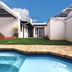 A swimming pool in front of a house at Selton Guesthouse in Cape Town