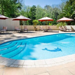 A swimming pool with sun loungers and umbrellas at Southern Light Country House in Constantia, Cape Town