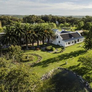 An aerial view of a white house with palm trees at Springfontein Wine Estate in Stanford