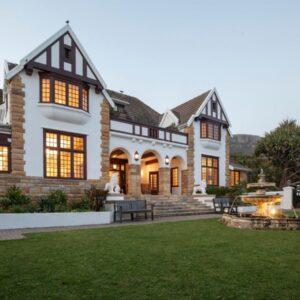 A house with a fountain in the yard at St James Guest Houses in Kalk Bay