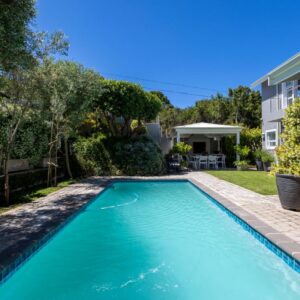 A swimming pool in the backyard of a home at Stableford Beachhouse Top b&b in Plettenberg Bay