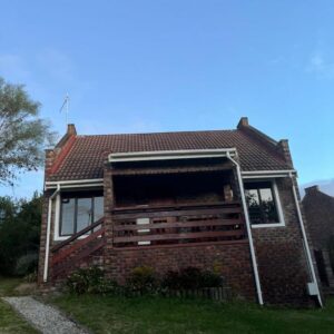 A brick house with its door open at Sunera Cottages in Plettenberg Bay