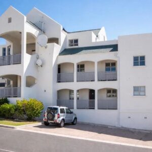 A white building with a car parked in front of it at Sunset Heights, Sondela Close, Self Catering in Langebaan