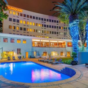 A hotel with a swimming pool in front of a building at SunSquare Cape Town Gardens in Cape Town