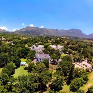 An aerial view of a house with mountains in the background at The Alphen Boutique Hotel & Spa in Cape Town