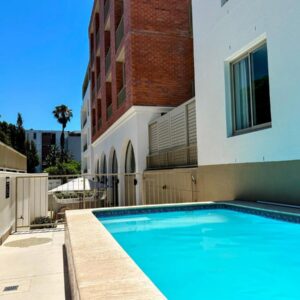 A swimming pool in front of a building at The Braemar - Cape 8 Collection in Cape Town