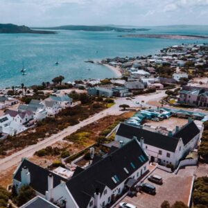 An aerial view of a town next to the water at The Farmhouse Hotel in Langebaan