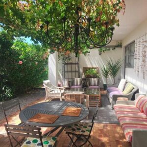 An outdoor patio with a table and chairs at The Lily House Hermanus - Central Private Cottages in Hermanus