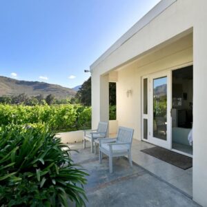 A patio with two chairs and a table on a house at The Little Vineyard Cottage in Franschhoek