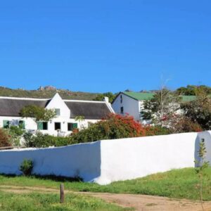 A white retaining wall in front of a house at The Old Village in Citrusdal