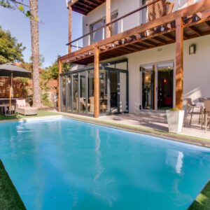 A swimming pool in front of a house at The One 8 Hotel in Green Point, Cape Town