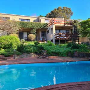 A house with a swimming pool in front of it at The Salt House Guest House in Hout Bay in Hout Bay