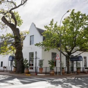 A white building on the side of a street at The Stellenbosch Hotel in Stellenbosch
