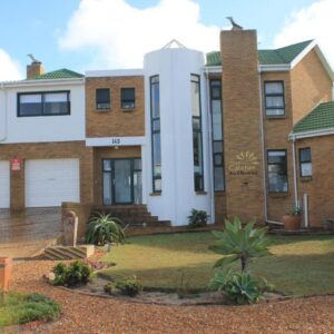 A large brick house with a garage at The Sun Catcher Bed & Breakfast in Struisbaai