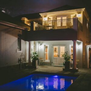 A house with a swimming pool at night at The Victorian Goose in Cape Town