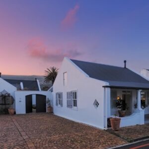 A white house with a black roof at The Vishuis in Hermanus