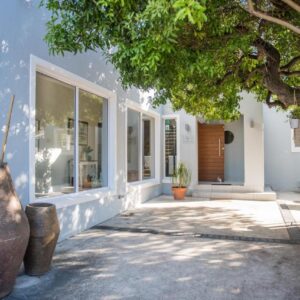 A home with two large vases in front of a building at The Whale on Main B&B in Hermanus