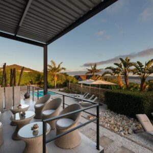 A patio with a bunch of chairs and a pool at THEBLOEM Guest Suites by Knysna Paradise Collection in Knysna