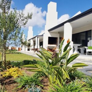 A house with a garden in front of it at Three Feathers Cottages in Langebaan