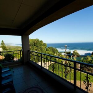 A balcony with a view of the ocean at Tranquil Shores in Wilderness