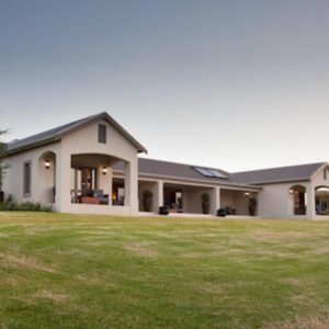 The farmhouse-style suites on a lawn at Under Oaks The Vineyard Suites in Paarl