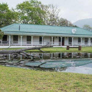 A house with a fallen tree in front of a pond at Valmont Estate in Plettenberg Bay
