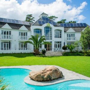 A large house with solar panels on the roof at Vida Nova Retreat in Hout Bay